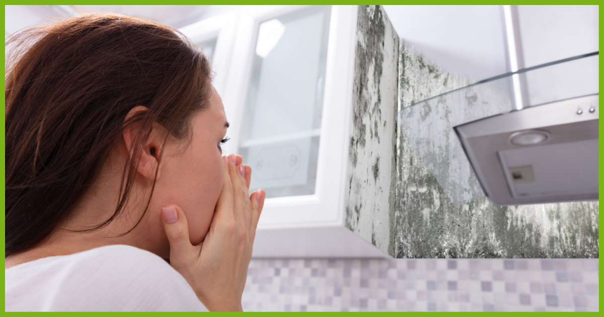 woman gasping at the sight of mold in the kitchen